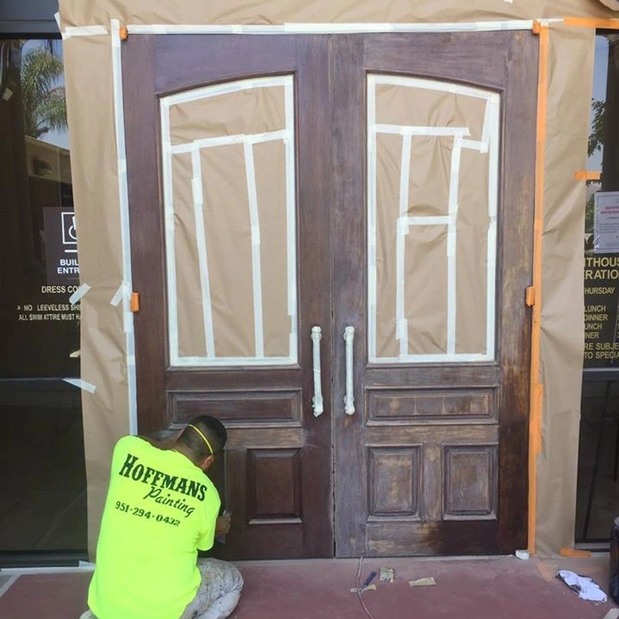 Painter working on a door preparation.