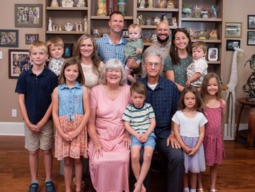 Large family gathered in living room for a photo.