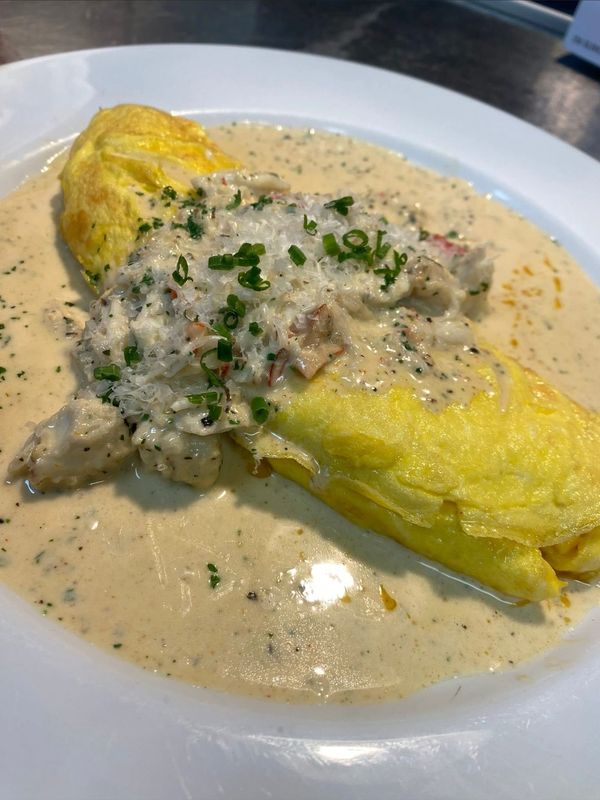 Omelette covered in creamy mushroom sauce.