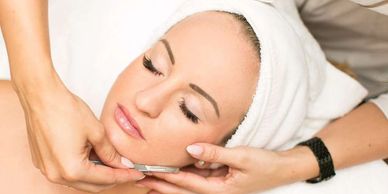 Top view of a girl having a face massage with a machine