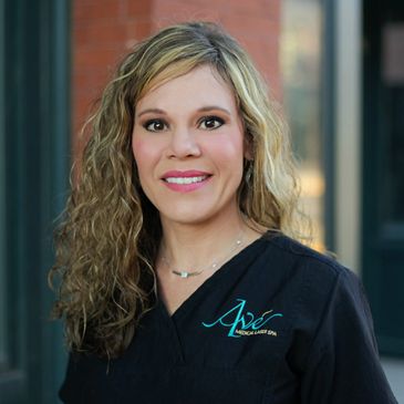 Close up shot of a lady with black dress smiling at the camera