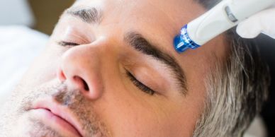 A person giving massage therapy to a man with a machine