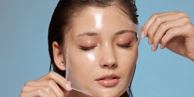 Close up image of a girl removing face mask from the face