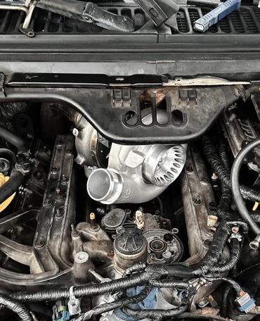 Close-up of a car engine with a newly installed turbocharger.