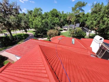 Red tile roof replacement in progress on a Lake Mary, FL home