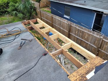 Wood framing being rebuilt during a flat roof project in Seminole County, FL