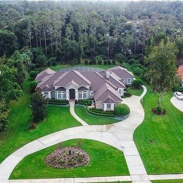 Aerial view of a completed roof replacement on a large home in Lake Mary, FL by O'John Roofing