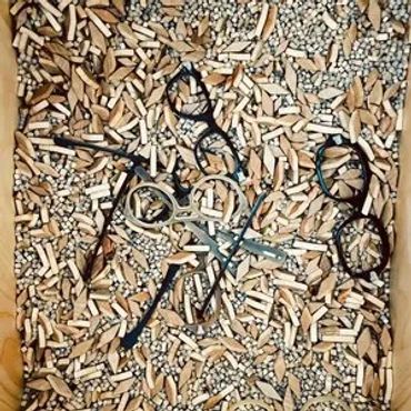 buffalo horn eyeglass frames in their parts in a wood chip tumbler