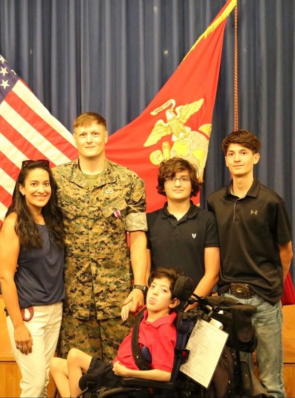 Family of 5 father male in a marine corps uniform with wife and 3 sons