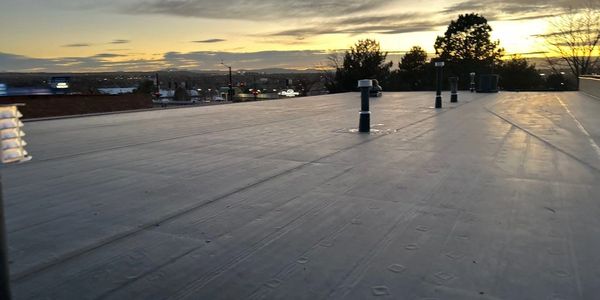 EPDM fully adhered system installed on Midas in centennial Colorado on County line road. 6" ISO 