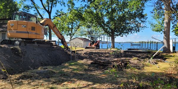 Professional excavation and site preparation underway on a premier lakeside lot in Becker County.