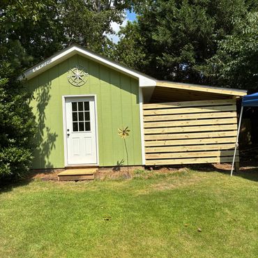 Added roof overhang to side of shed