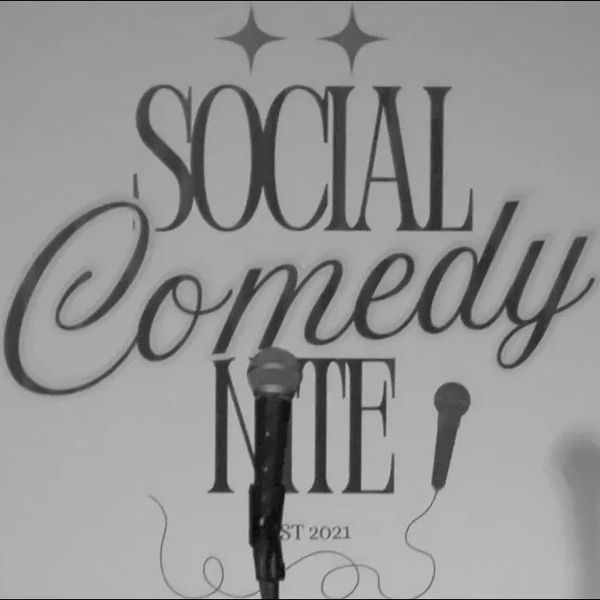 Microphone in front of a Social Comedy Nite sign with two stars.