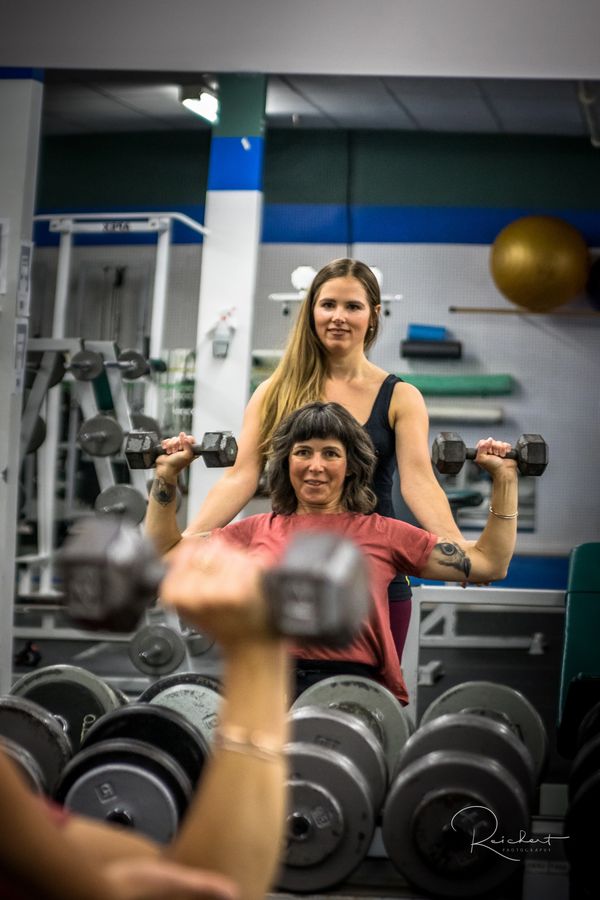 Fitness coach teaching student photographed by Reichert Photography