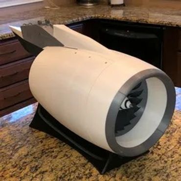 A white model jet engine displayed on a kitchen countertop.