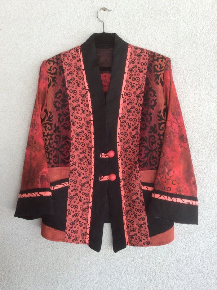 Three adults focused on drawing portraits on easels in an art class.