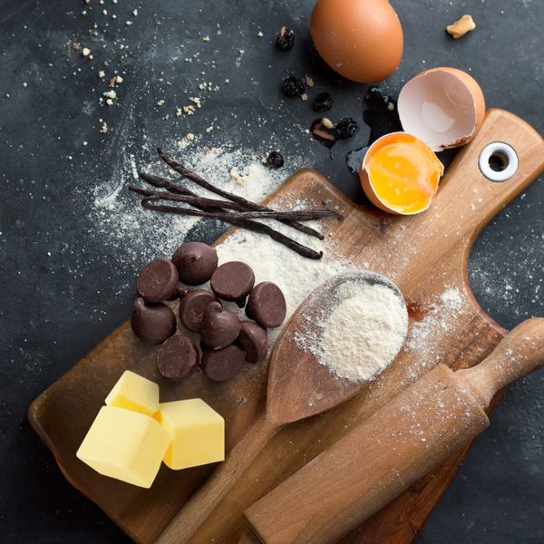 Baking ingredients and tools on a wooden board.
