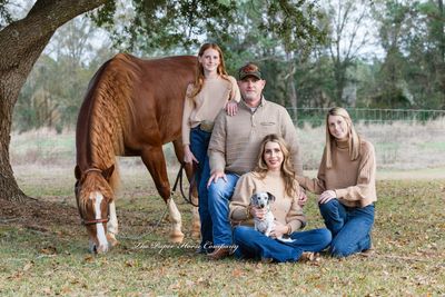 Image of a young family with their equine.