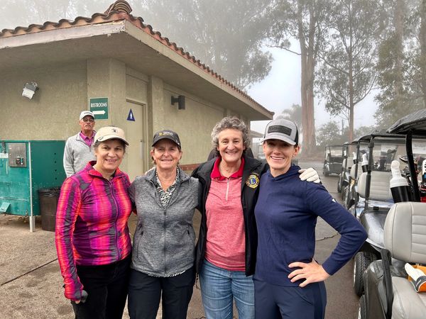 Ladies beside a golf cart