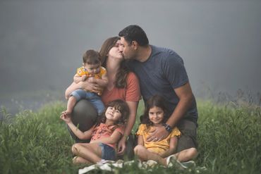 Family of 5 posing for a fun photo on the foothills parkway in the Smoky Mountain National Park.