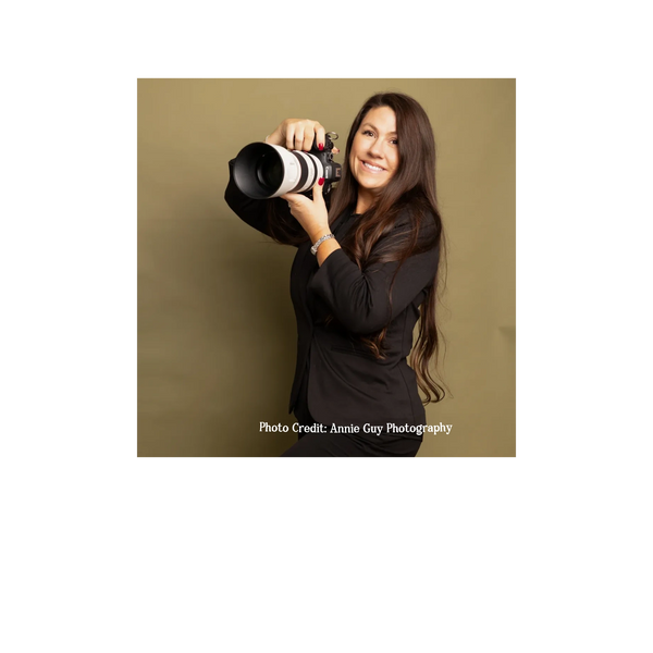 Photo of Celeste Martinez in a studio holding a canon camera with a 70-200 lens