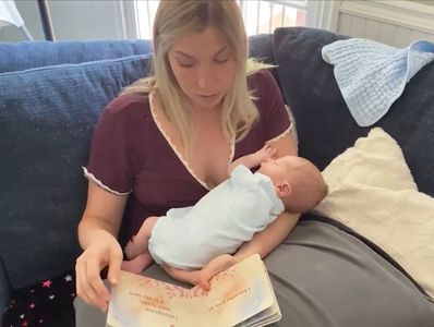 Mama reading "Here I Am" to her baby, Oliver.
