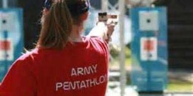 A woman wearing red t shirt is holding a gun