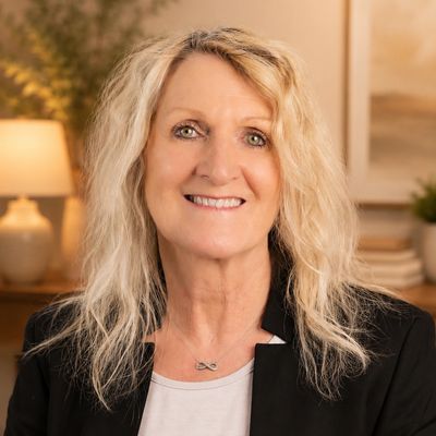 Smiling woman with blonde hair in a professional setting.