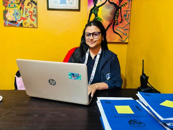 Young woman working on a laptop in a colorful office.