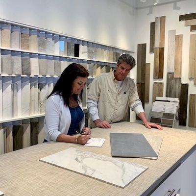Contractor and homeowner reviewing tile selections during a design consultation