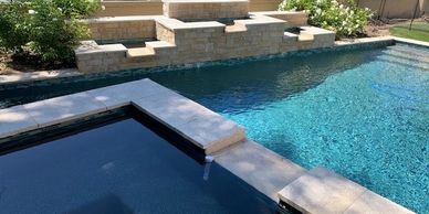 Custom backyard with pool,  outdoor kitchen, covered patio, and fire pit