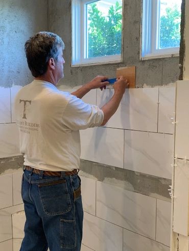 Dino, installing tile, showcasing his hands-on expertise in Laguna Niguel.