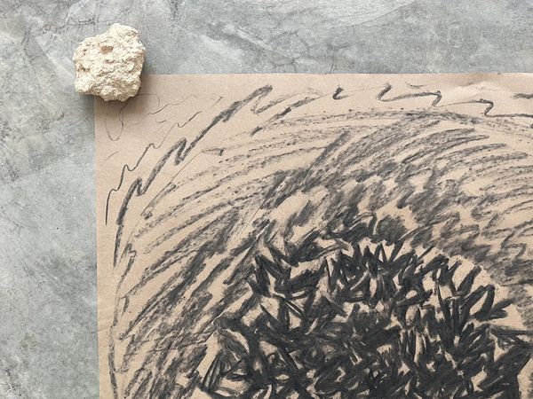 Abstract charcoal drawing with dense black strokes on brown paper.