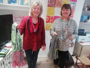 Two ladies modelling the upcycled T-shirt necklaces they created at Anna's Funky Art Studio