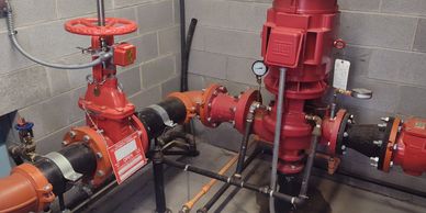 Industrial pipes and valves in a utility room.