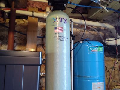 Water softener system setup in a basement.