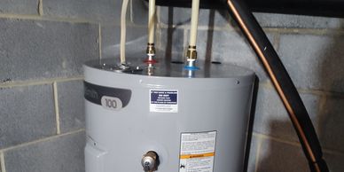 Water heater installed in a basement corner.