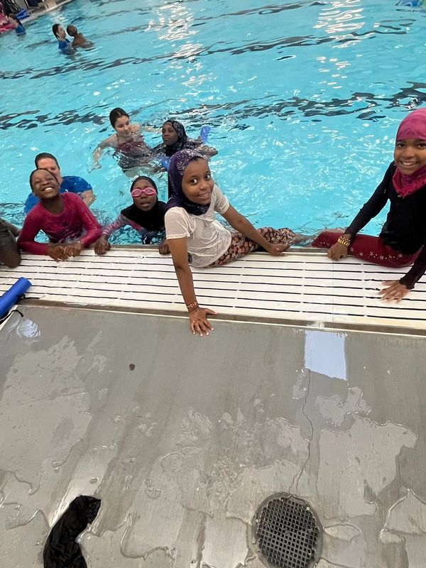 Children enjoying time in an indoor swimming pool.