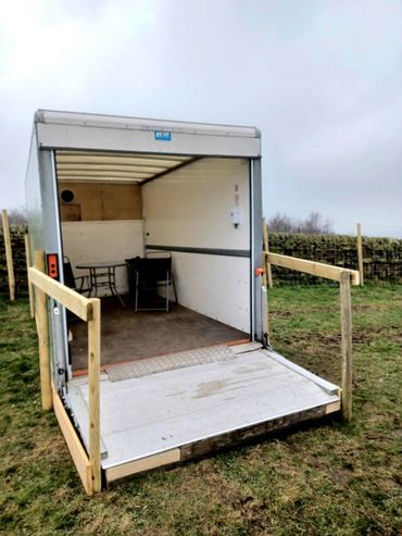 Our shelter which includes a table and chairs, clock, bin, poo bag dispenser and water bowls