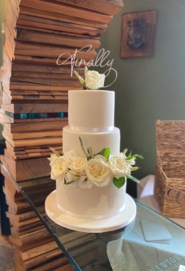 3 tiered fondant wedding cake with fresh flowers 