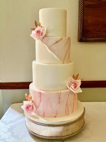 Fondant wedding cake with pink marble effect and sugar flowers 