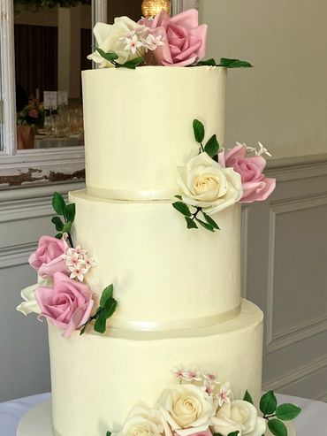 Buttercream wedding cake with pink and cream sugar roses