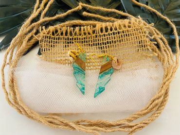 Handcrafted blue and wood resin earrings on rustic burlap and twine.