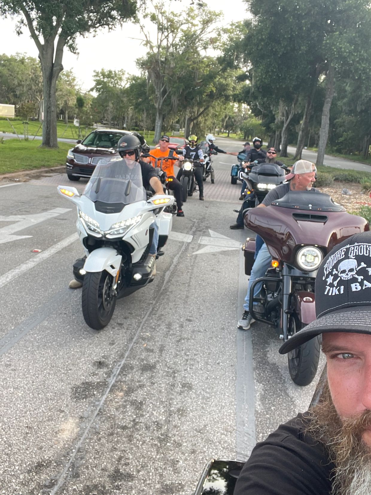 Group of bikers riding on a street.