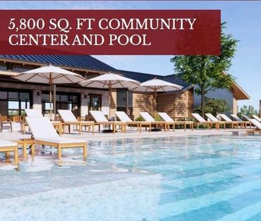 Spacious community center with a large pool and lounge chairs under umbrellas.