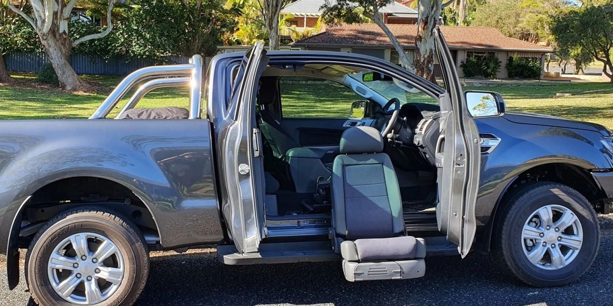 Pickup truck with passenger seat rotated outside.