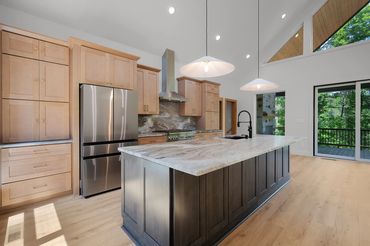 10 foot island with granite countertop in an open concept kitchen with stainless steel appliances