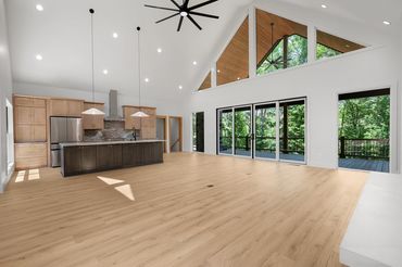 View of the kitchen with 10 foot island and giant slider doors and oversized windows