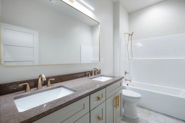 Custom bathroom with custom cabinets, tile floor, granite countertop & fiberglass shower tub insert