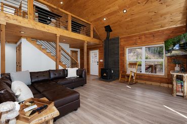 Interior stained wood shiplap and tongue & groove with a rebar railing on the exposed loft & stairs